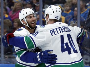 Elias Pettersson is congratulated by Josh Leivo after scoring during the first period.