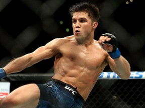 Henry Cejudo kicks Demetrious Johnson (out of frame) in the second round of the UFC Flyweight Title Bout during UFC 227 at Staples Center on Aug. 4, 2018 in Los Angeles.