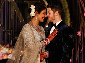In this Tuesday, Dec. 4, 2018, file photo, Priyanka Chopra and Nick Jonas stand for photographs at their wedding reception in New Delhi, India.