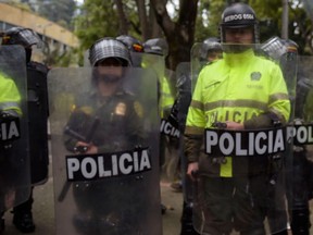 Colombian riot police officers are pictured in this September 6, 2018 file photo during a protest against the prohibition of bearing a minimum dose of marijuana for personal use in Bogota. (RAUL ARBOLEDA/AFP/Getty Images)