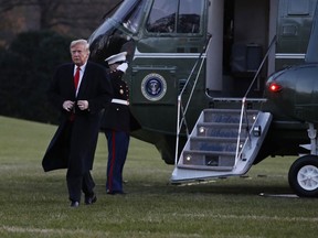U.S. President Donald Trump exits the Marine One helicopter as he returns to the White House, Friday, Dec. 7, 2018, in Washington, after speaking at the 2018 Project Safe Neighborhoods National Conference.
