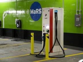 GE WattStations (wall mounted) and Electric Vehicle Chargers Ontario (EVCO), white free standing unit, at the parking lot under the MaRS Centre in Toronto on Thursday Jan. 18, 2018.