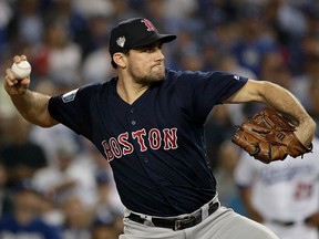 In this Oct. 26, 2018, file photo, Boston Red Sox starting pitcher Nathan Eovaldi throws against the Los Angeles Dodgers during the 12th inning in Game 3 of the World Series baseball game in Los Angeles.