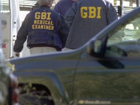 File photo of two Georgia Bureau of Investigation workers.  (Photo by Erik S. Lesser/Getty Images)