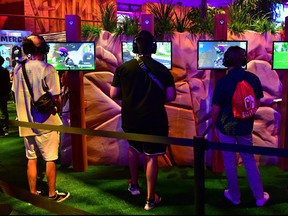 Gaming fans play the game 'Fortnite' at the 24th Electronic Expo, or E3 2018 in Los Angeles, California on June 13, 2018, where hardware manufacturers, software developers and the video game industry present their new games between June 12-14. (FREDERIC J. BROWN/AFP/Getty Images)
