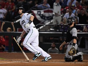 In this Oct. 4, 2017, file photo, Paul Goldschmidt of the Arizona Diamondbacks watches hits a three-run home run during the bottom of the first inning of the National League Wild Card game against the Colorado Rockies at Chase Field on  in Phoenix, Ariz.