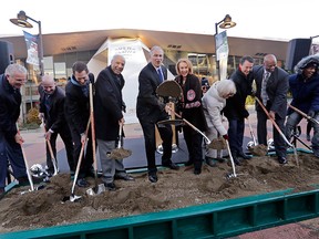 Gov. Jay Inslee, centre left, tosses a chunk of frozen sand as Seattle Mayor Jenny Durkan looks on from his left and former Seattle SuperSonics head coach Lenny Wilkens stands on his right with other officials during a ceremonial groundbreaking of a renovation of the arena at Seattle Center Wednesday, Dec. 5, 2018, in Seattle.