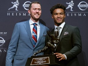 Oklahoma football coach Lincoln Riley, left, poses with Oklahoma quarterback Kyler Murray, winner of the Heisman Trophy, Saturday, Dec. 8, 2018, in New York.