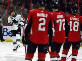 Ottawa Senators players look on as San Jose Sharks' Erik Karlsson is welcomed onto the ice by fans during first period NHL action in Ottawa on Saturday, Dec. 1, 2018.