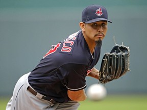 In this Sept. 30, 2018, file photo, Cleveland Indians starting pitcher Carlos Carrasco throws during the first inning of a baseball game against the Kansas City Royals in Kansas City, Mo.