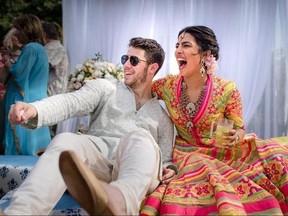 In this Friday, Nov. 30, 2018 handout photo released by Raindrop Media, Bollywood actress Priyanka Chopra and Nick Jonas celebrate during a mehendi ceremony, a day before their wedding, at Umaid Bhawan in Jodhpur, India.