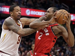 The Raptors' Kawhi Leonard (right) drives past the Cavaliers' Channing Frye during the second half in Cleveland Saturday, Dec. 1, 2018.