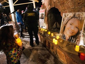 In this Dec. 13, 2018 file photo, community members hold a candlelight vigil for Kelsey Berreth under the gazebo of Memorial Park in Woodland Park, Colo.