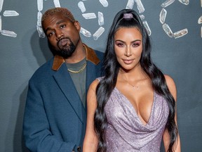 Kanye West and Kim Kardashian West attend the the Versace fall 2019 fashion show at the American Stock Exchange Building in lower Manhattan on Dec. 2, 2018.