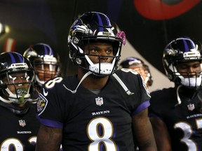 In this Nov. 18, 2018, file photo, Ravens quarterback Lamar Jackson (8) walks in a tunnel to the field as the team is introduced before an NFL game against the Bengals in Baltimore.