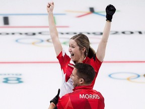 Canadians Kaitlyn Lawes and John Morris react after defeating Switzerland to win gold during mixed doubles curling action at the 2018 Olympic Winter Games in Gangneung, South Korea on Feb. 13, 2018.