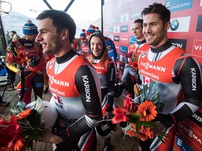 Canada's Reid Watts, from left, Kyla Graham, Justin Snith and Tristan Walker celebrate after finishing third in a World Cup luge relay event in Whistler, B.C., on Saturday, Dec. 1, 2018.