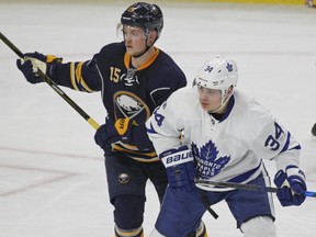 Buffalo Sabres forward Jack Eichel (15) and Toronto Maple Leafs forward Auston Matthews fight for position during the third period of an NHL hockey game, Saturday, March 25, 2017, in Buffalo, N.Y. (AP Photo/Jeffrey T. Barnes)