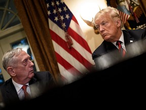In this file photo taken on Oct. 23, 2018, U.S. Secretary of Defense James Mattis (L) and U.S. President Donald Trump wait for a meeting with military leaders in the Cabinet Room of the White House in Washington, DC. Mattis announced he will be retiring at the end of February.