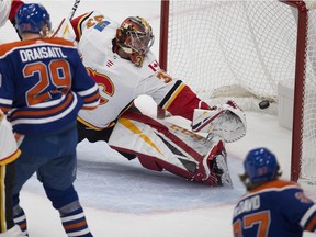 Edmonton Oilers Connor McDavid (97) scores on Calgary Flames goalie David Rittich (33) during first period NHL action on Sunday, Dec. 9, 2018, in Edmonton.