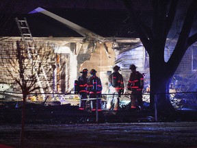 In this Dec. 25, 2018 photo, first responders survey the scene where a plane crashed into a home in Sioux Falls, S.D.