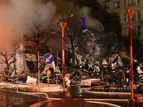 Firefighters carry on rescue works after an explosion at a restaurant in Sapporo, in the northern Hokkaido prefecture on Dec. 16, 2018.