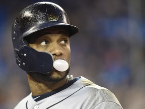 Seattle Mariners' Robinson Cano blows a bubble as he looks towards the field after he lined out against the Blue Jays in Toronto on Wednesday May 9, 2018. (THE CANADIAN PRESS/Nathan Denette)