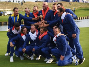 Captain Thomas Bjorn of Europe holds The Ryder Cup as Europe celebrate victory following the singles matches of the 2018 Ryder Cup at Le Golf National on September 30, 2018 in Paris, France.  (Photo by /)