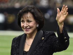 In this Sept. 16, 2018, photo, New Orleans Saints owner Gayle Benson waves before an NFL football game against the Cleveland Browns in New Orleans. New Orleans Saints and Pelicans owner Benson has paid off nearly $100,000 worth of layaway orders at a New Orleans Walmart. News outlets reported Tuesday, Dec. 4, 2018, that Benson has paid off more than 400 orders at the Tchoupitoulas Street store. NOLA.com/The Times-Picayune reports a Saints spokesman says Benson made the gift on her own.(AP Photo/Bill Feig) ORG XMIT: TKSK105