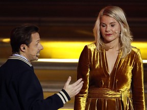 In this photo taken Monday Dec.3, 2018, French DJ and musician Martin Solveig, left, talks to Olympique Lyonnais' Ada Hegerberg, of Norway, during the Golden Ball (Ballon d'Or) award ceremony at the Grand Palais in Paris. (AP Photo/Christophe Ena)