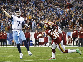 Blaine Gabbert of the Tennessee Titans throws a touchdown pass to beat the Washington Redskins while defended by D.J. Swearinger of the Washington Redskins during the fourth quarter at Nissan Stadium on Dec. 22, 2018 in Nashville, Tenn.