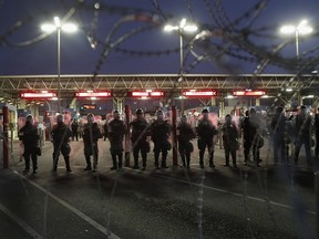 U.S. Customs and Border Protection (CBP), officers block the Otay Mesa port of entry from Mexico into the United States early on Dec.1, 2018 as seen from Tijuana, Mexico.