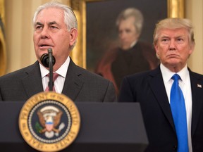 In this file photo taken on Feb. 1, 2017 Rex Tillerson speaks after being sworn in as U.S. secretary of state while U.S. President Donald Trump listens in the Oval Office at the White House in Washington, D.C.