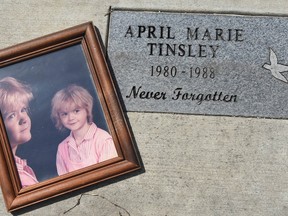 In this March 30, 2018, file photo, a photo of April Tinsley was placed in the garden that was dedicated in her honour near where she disappeared in Fort Wayne, Ind.