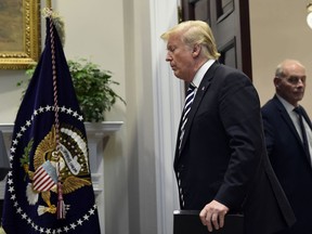 U.S. President Donald Trump walks in to the Roosevelt Room of the White House in Washington, to talk about immigration and border security, on Nov. 1, 2018. Chief of Staff John Kelly is at right.