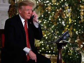 U.S. President Donald Trump speaks on the phone sharing updates to track Santa's movements from the North American Aerospace Defense Command (NORAD) Santa Tracker on Christmas Eve, Monday, Dec. 24, 2018.