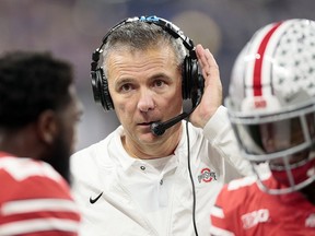 Ohio State head coach Urban Meyer listens on a head set on the sideline during the first half of the Big Ten championship NCAA college football game against Northwestern, Saturday, Dec. 1, 2018, in Indianapolis. (AP Photo/AJ Mast)