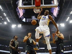 Golden State Warriors' Andre Iguodala dunks during the first half of an NBA basketball game against the Milwaukee Bucks Friday, Dec. 7, 2018, in Milwaukee.