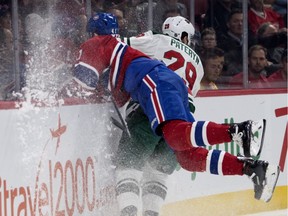 Canadiens left wing Paul Byron crashes face first in to the boards after attempting a big hit on Minnesota Wild defenseman Greg Pateryn during NHL action in Montreal on Monday January 7, 2019.