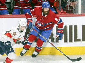 Canadiens Jordie Benn turns back on defence next to Florida Panthers Denis Malgin, left, during first period in Montreal on Jan. 15, 2019.