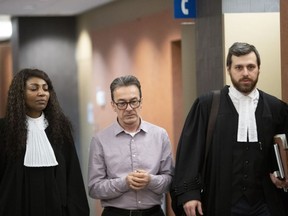 Michel Cadotte leaves the courtroom with his lawyers, Elfride Duclervil, left, and Nicolas Welt, in Montreal, on Thursday, Jan. 17, 2019.