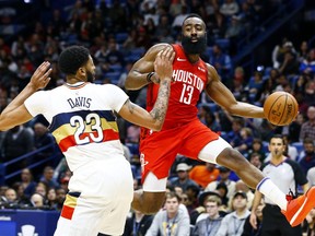 Houston Rockets guard James Harden passes the ball around New Orleans Pelicans' Anthony Davis last week.