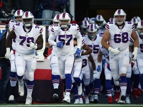 Lorenzo Alexander #57 and the Buffalo Bills runs onto the field before the game against the New England Patriots at Gillette Stadium on December 23, 2018 in Foxborough, Massachusetts.