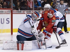 Goalie Cayden Primeau of Team USA stops Nikita Shashkov of Russia during Friday's semifinal action at the World Junior Championship at Rogers Arena in Vancouver. Quinn Hughes of the U.S. helps his goaltender on the play.