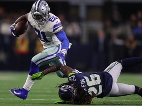 Ezekiel Elliott of the Cowboys breaks a tackle attempt by Shaquill Griffin of the Seahawks in the fourth quarter during the Wild Card Round at AT&T Stadium on Jan. 5, 2019 in Arlington, Texas.