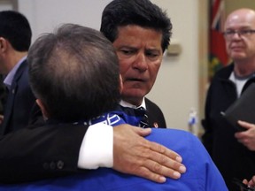 Unifor National President Jerry Dias, centre, greets an autoworker after addressing the media on , Jan. 8, 2019, in Windsor, Ont.