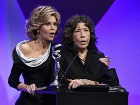 In this Feb. 21, 2017 file photo, presenters Jane Fonda, left, and Lily Tomlin address the audience during the 19th Annual Costume Designers Guild Awards in Beverly Hills, Calif.