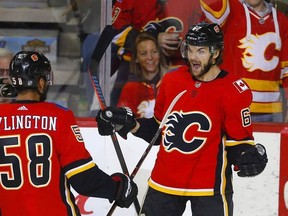 Calgary Flames Michael Frolik, right, celebrates his goal on Florida Panthers with teammate Oliver Kylington in NHL hockey action at the Scotiabank Saddledome in Calgary, on Friday Jan. 11, 2019.
