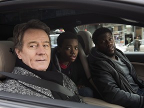 This image released by STXfilms shows Bryan Cranston, from left, Jahi Di'Allo Winston, and Kevin Hart in a scene from "The Upside." (David Lee/STXfilms via AP)
