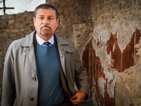 The general manager of the archaeological park of Pompeii, Massimo Osanna, stands by a fresco at the Schola Armaturarum building in Pompeii, Italy, Thursday, Jan. 3, 2019. (Cesare Abbate/ANSA via AP)